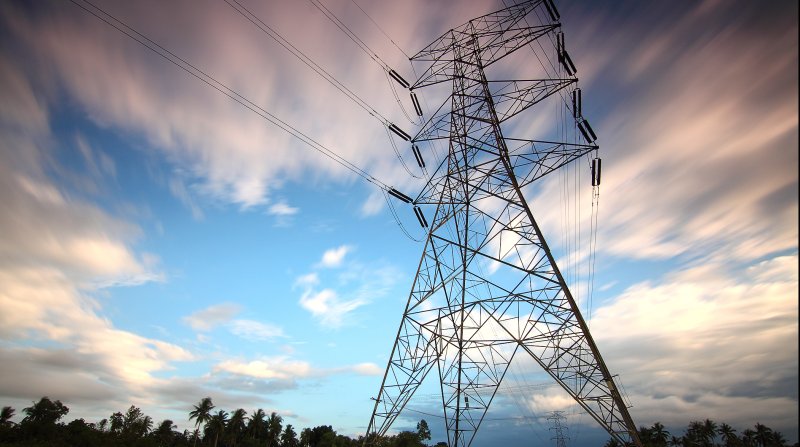 powerline in front of a cloudy blue sky